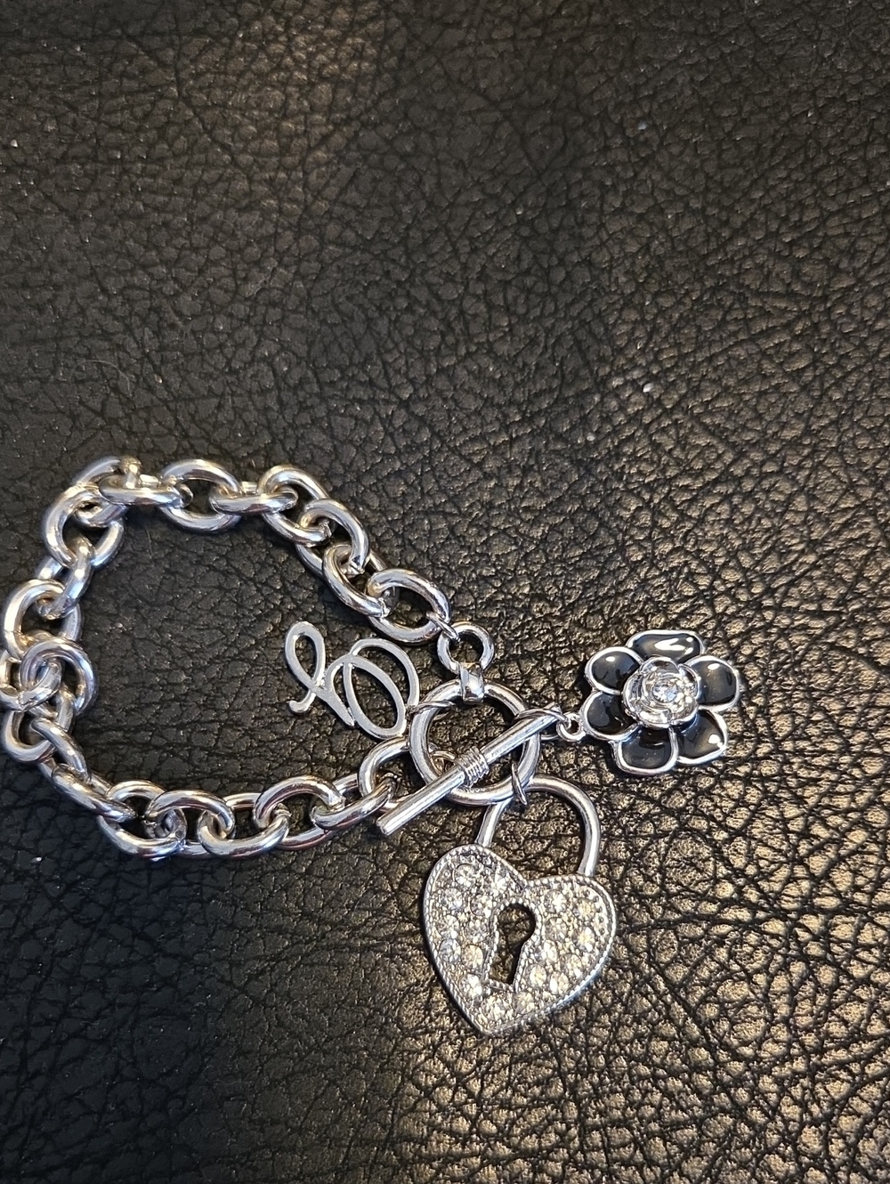Guess Silver Tone Heart Lock Charm Bracelet with Flower With Black Enamel Accent